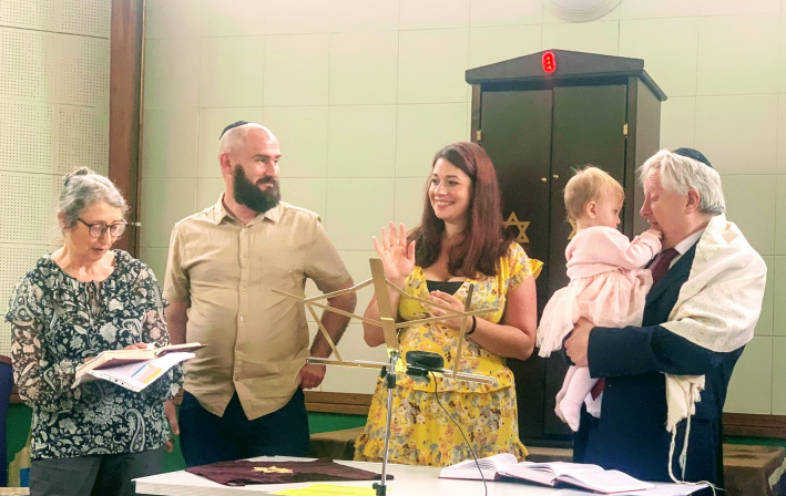 Rabbi Danny Rich conducts a baby blessing at Stevenage Liberal Synagogue